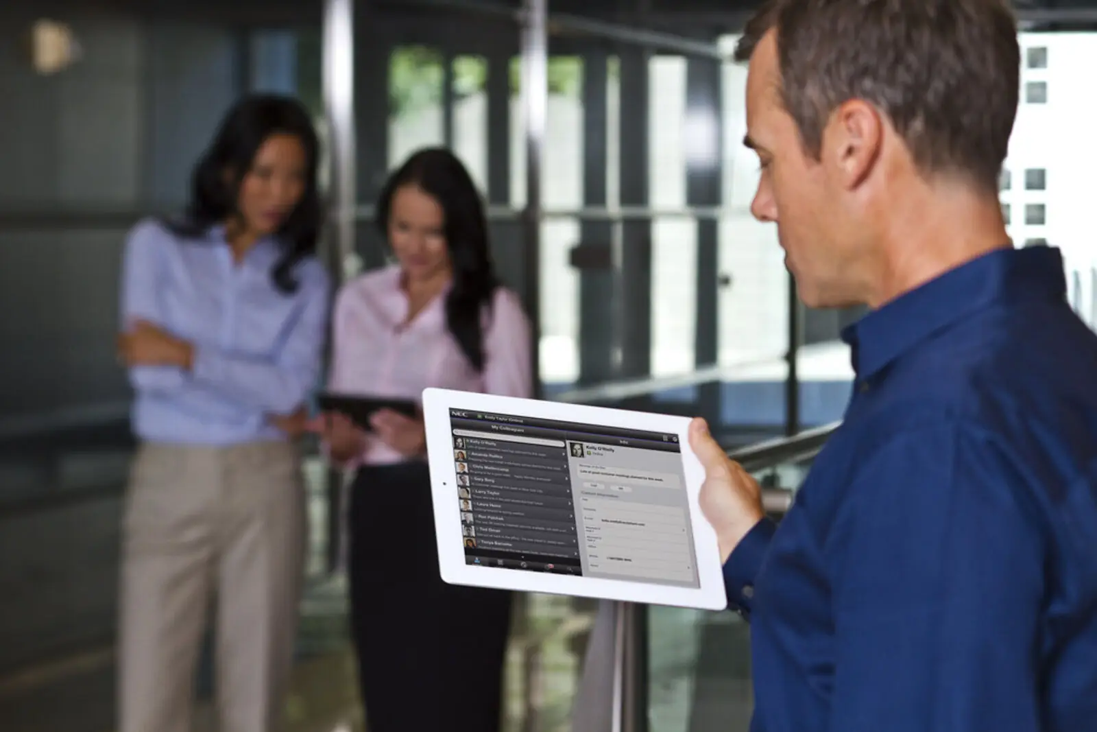 Two people discussing paperwork in a professional office setting