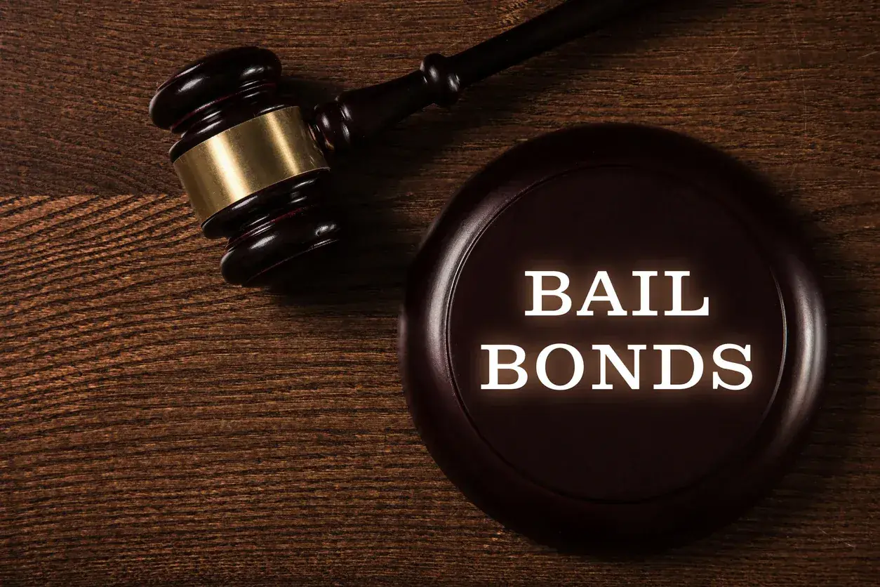 Judge's gavel resting beside a bail bonds plaque
