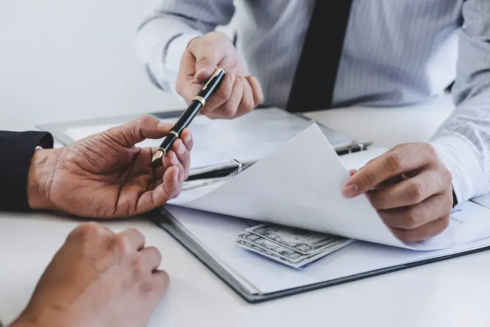 Bondsman reviewing documents with a client across a desk