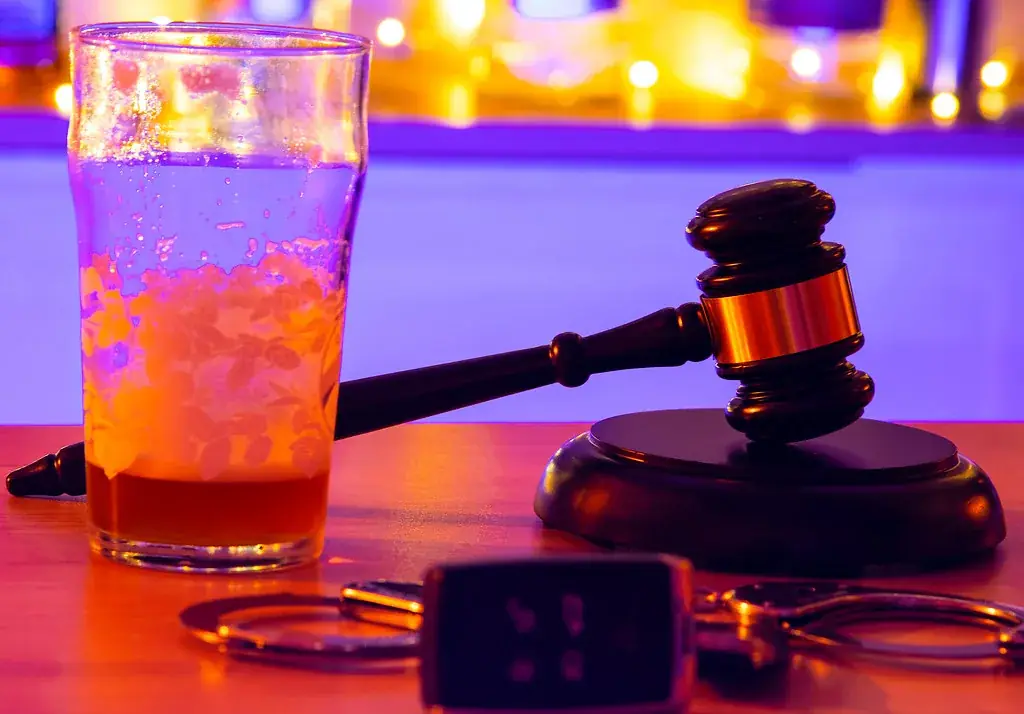 Car keys beside a drink illustrating impaired driving