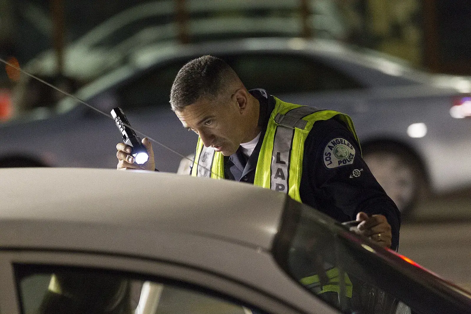 Police sobriety checkpoint set up on a roadway at night
