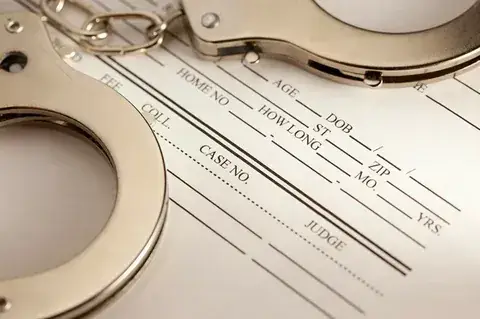 Handcuffs on a jail intake booking form