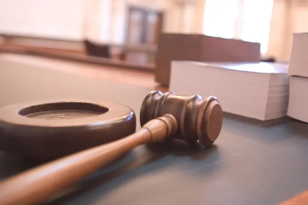 Judge's gavel resting on a courtroom bench